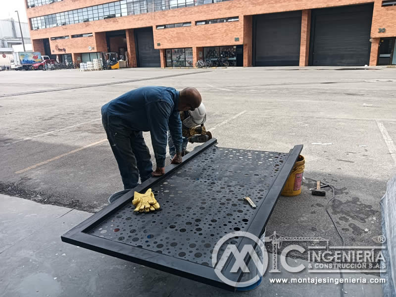 Acabado y ajuste de paneles metálicos perforados para portones decorativos en Bogotá, Colombia. Montajes, Ingeniería y Construcción MIC SAS.