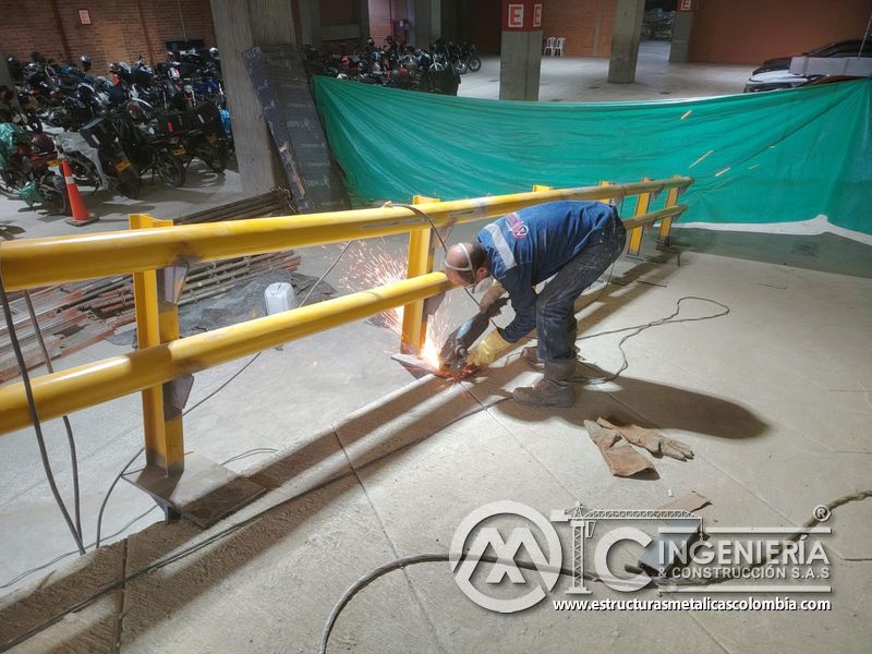 Pintura de barandas y señalización para rampas vehiculares acceso en Bogotá, Colombia. Montajes, Ingeniería y Construcción MIC SAS.