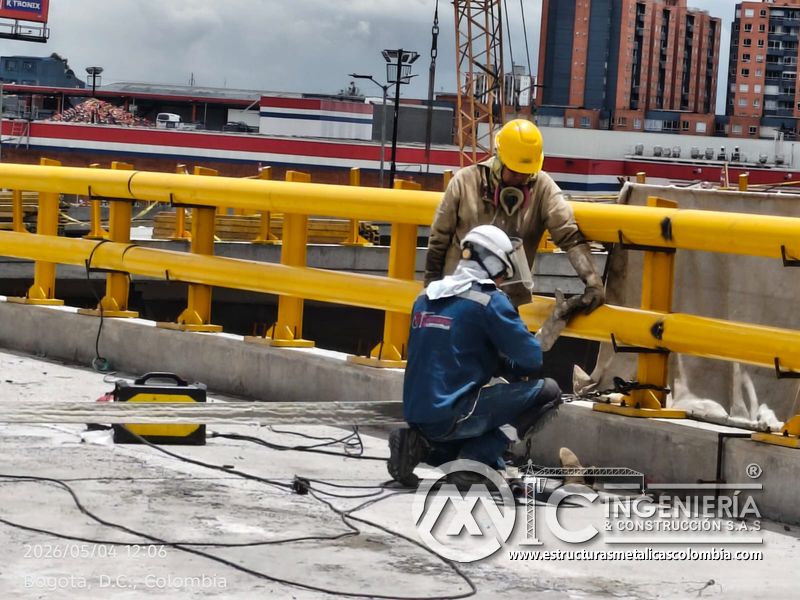 Trabajadores ajustando barandas y pasamanos amarillos del puente Venecia con fabricación e instalación profesional en Bogotá, Colombia. Montajes, Ingeniería y Construcción. MIC SAS. Trabajadores ajustando barandas y pasamanos amarillos del puente Venecia en Bogotá, Colombia. Montajes, Ingeniería y Construcción. MIC SAS.