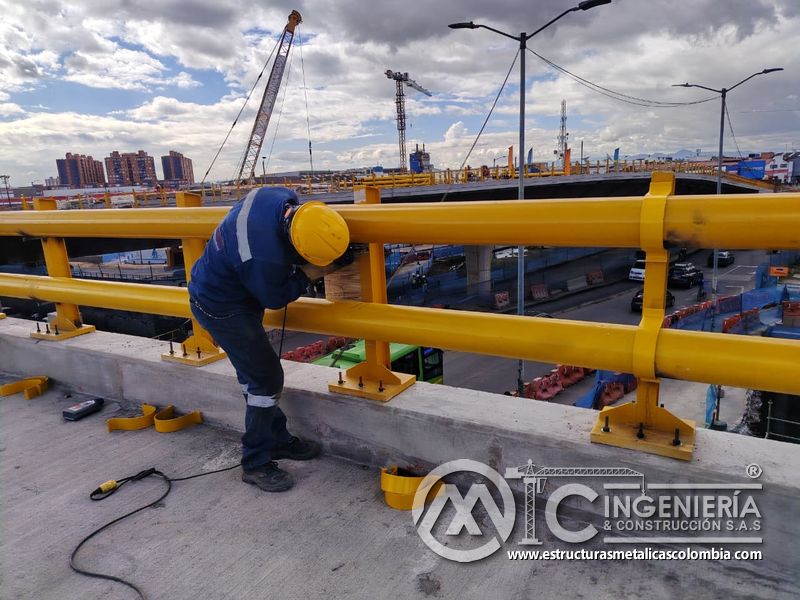 Trabajador ajustando barandas amarillas sobre la losa del puente Venecia con fabricación e instalación profesional en Bogotá, Colombia. Montajes, Ingeniería y Construcción. MIC SAS. Trabajador ajustando barandas amarillas sobre la losa del puente Venecia en Bogotá, Colombia. Montajes, Ingeniería y Construcción. MIC SAS.