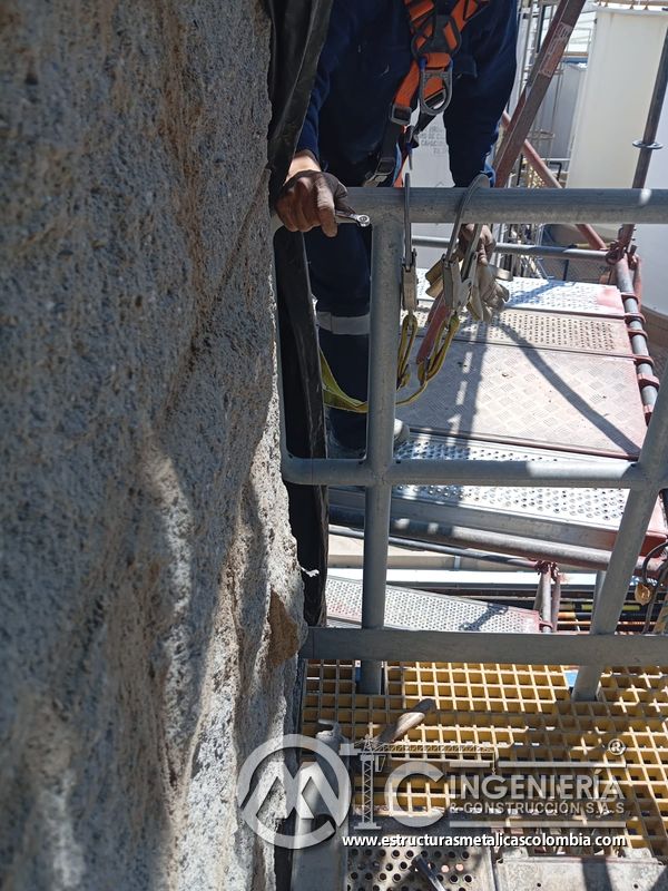 Trabajador ajustando baranda junto a persiana y andamio del Edificio eléctrico CCM - Brinsa en Bogotá, Colombia. Montajes, Ingeniería y Construcción. MIC SAS.