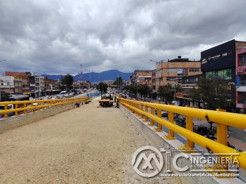 Recorra el firme granular entre barandas amarillas, antes de recibir las capas finales de rodadura vial en Bogotá, Colombia. Montajes, Ingeniería y Construcción. MIC SAS.