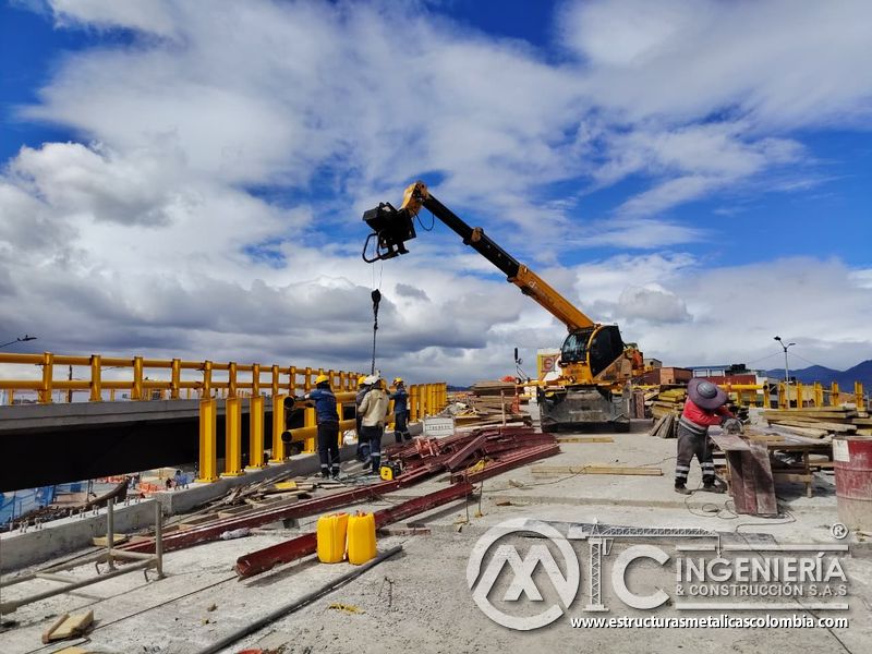 Eleve perfiles entre formaletas y vigas con equipo telescópico mientras el personal mantiene distancias en Bogotá, Colombia. Montajes, Ingeniería y Construcción. MIC SAS.