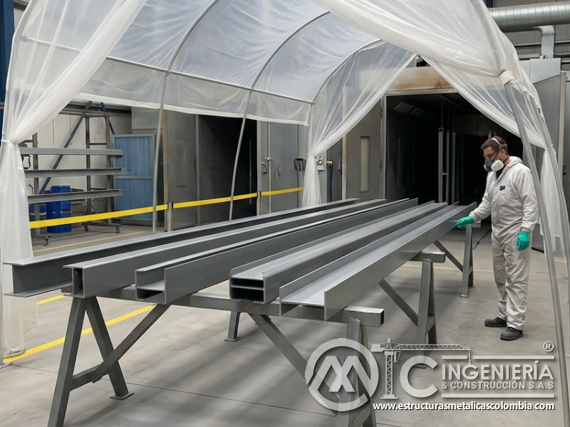 Protección de piezas metálicas durante curado de pintura industrial en Bogotá, Colombia. Montajes, Ingeniería y Construcción. MIC SAS.